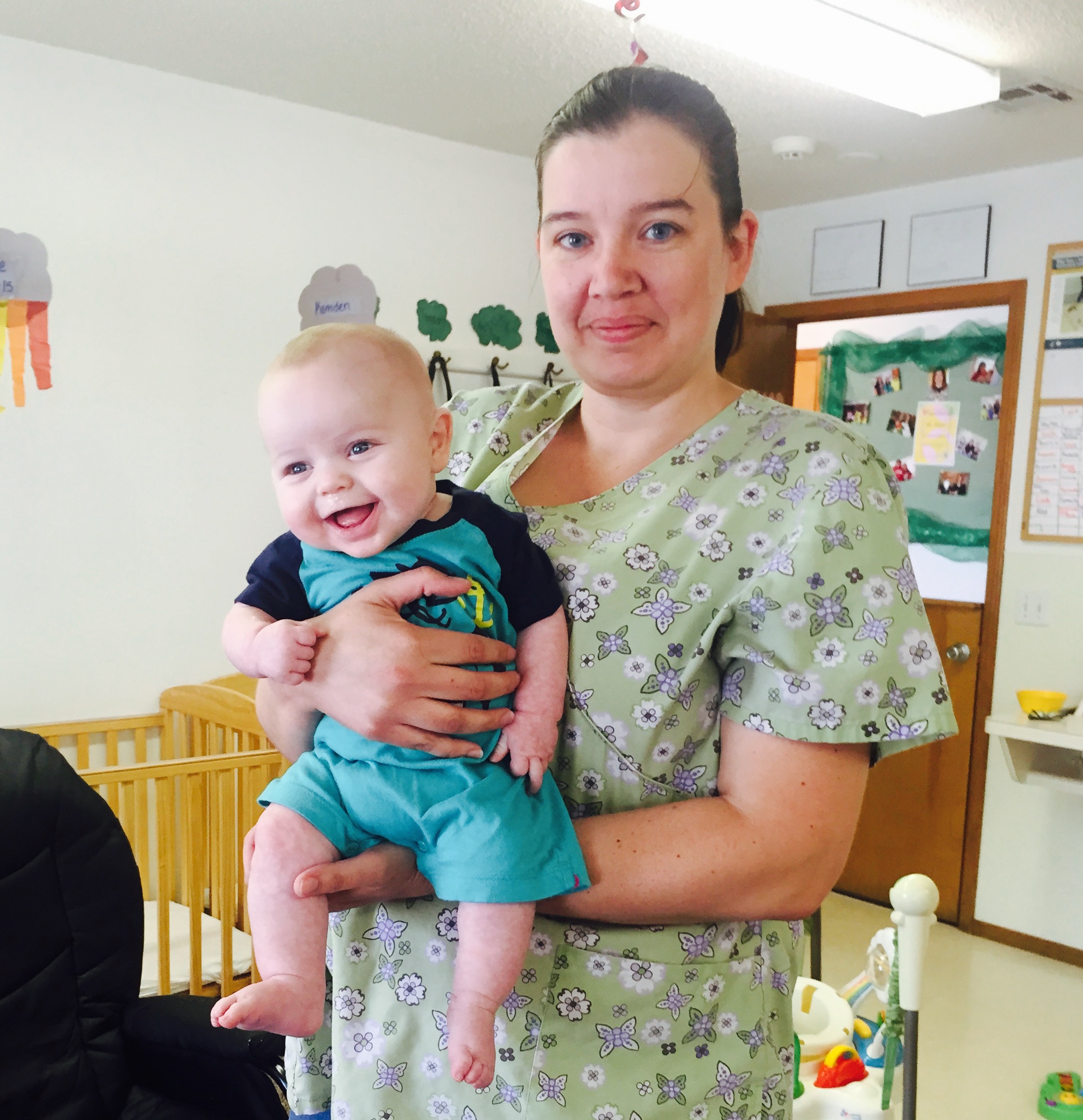 A picture of an infant and teacher